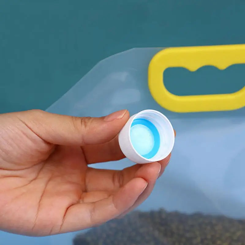 a hand holding a pill pill in front of a blue background