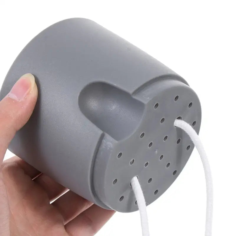 a hand holding a gray plastic mouse mouse