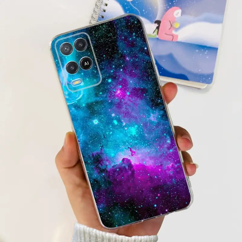 a person holding a phone case with a galaxy design