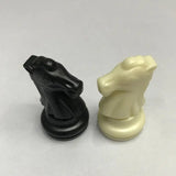 there are two chess pieces that are sitting on a table