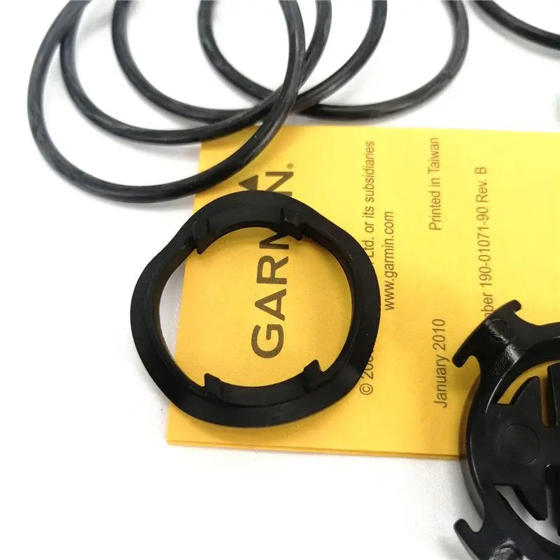 a set of black rubber rings on a yellow card