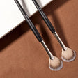 two brushes on a brown background