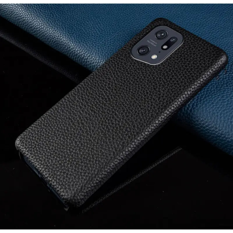 the back of a black leather case with a blue leather background