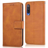 the back of a brown leather case with a card slot