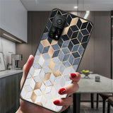 a woman holding a phone case with a gold and white geometric design
