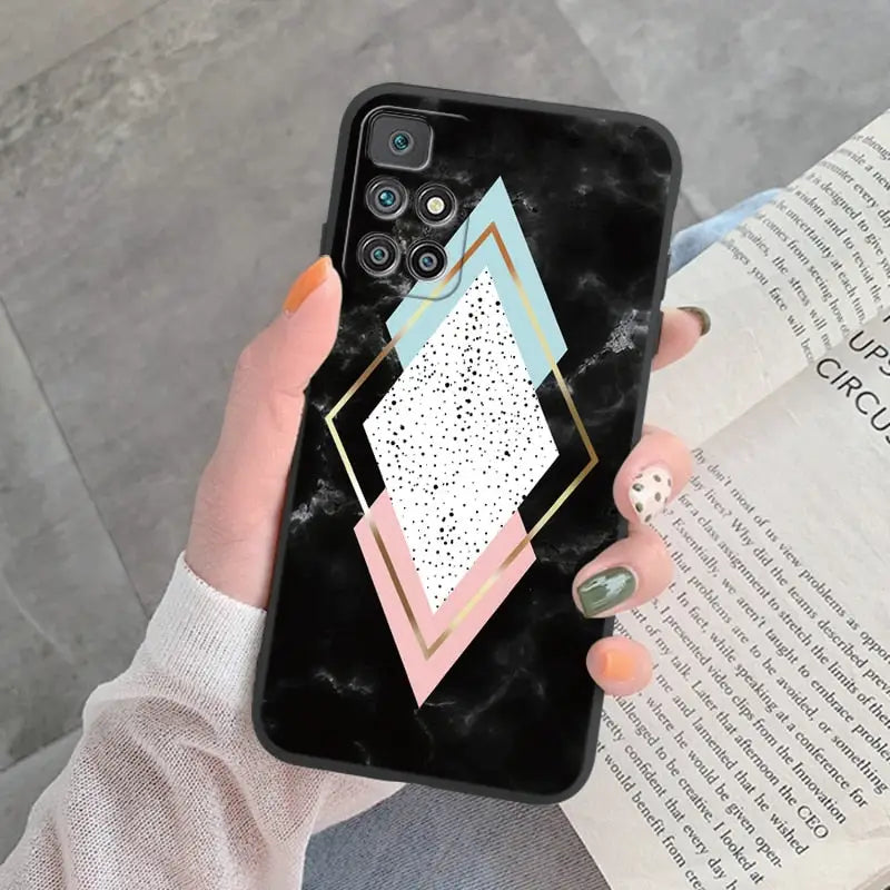 a woman holding a phone case with geometric shapes