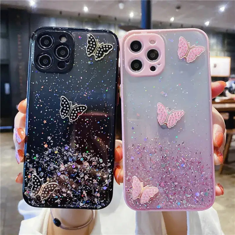 a girl holding up a phone case with glitter and butterflies