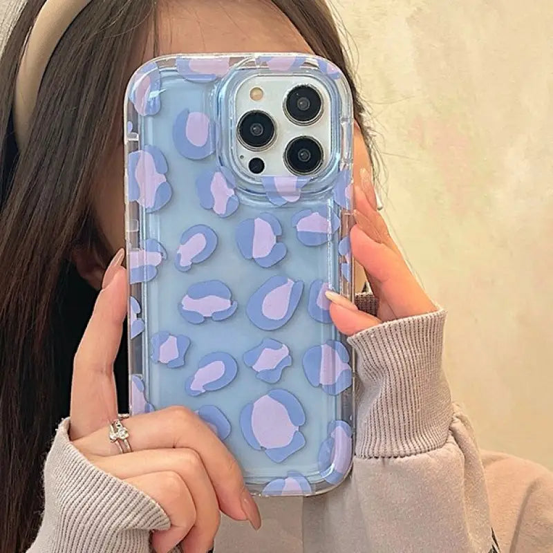 a girl holding up her phone case
