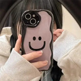 a girl holding a phone case with a smiley face on it