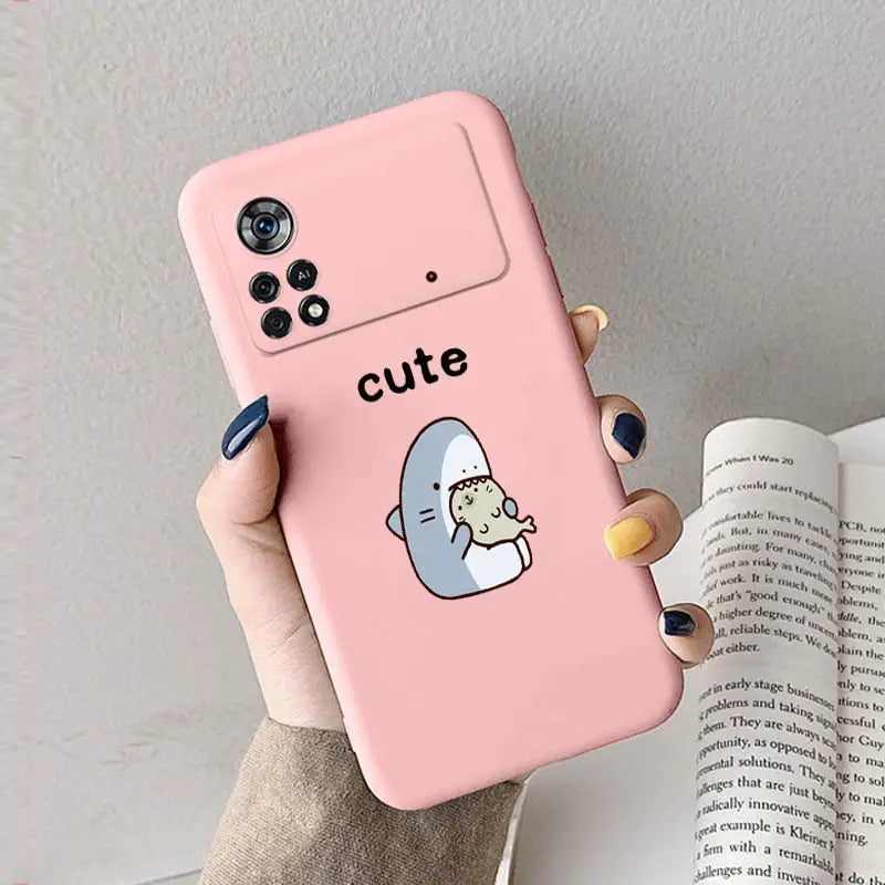 a girl holding a pink phone case with a cute little penguin