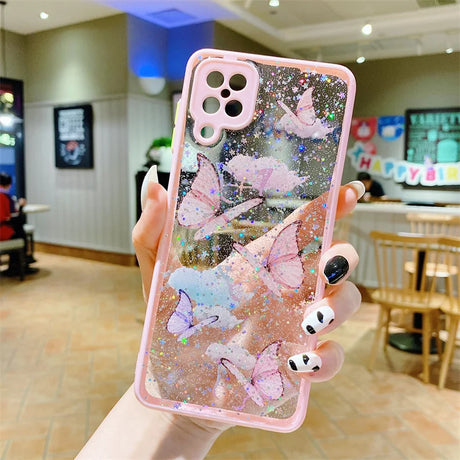 a girl holding up a pink phone case with glitter stars and unicorns