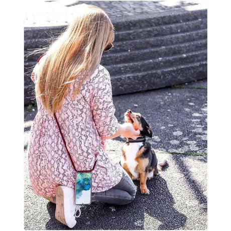 a little girl sitting on the ground with her dog