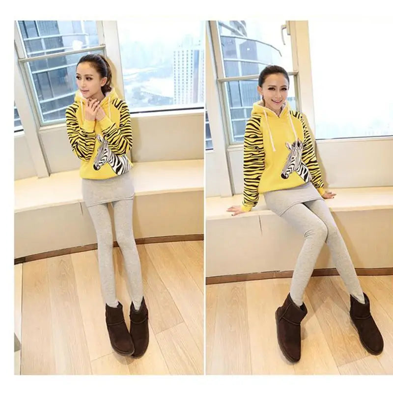 a girl wearing a yellow sweater and grey pants