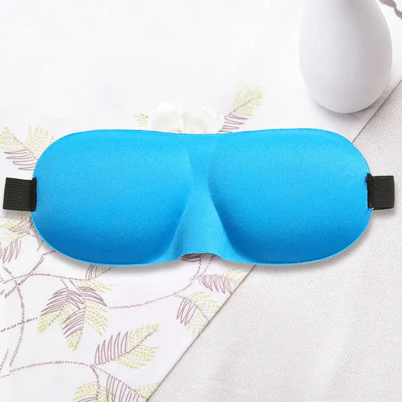 a blue eye mask with a black strap