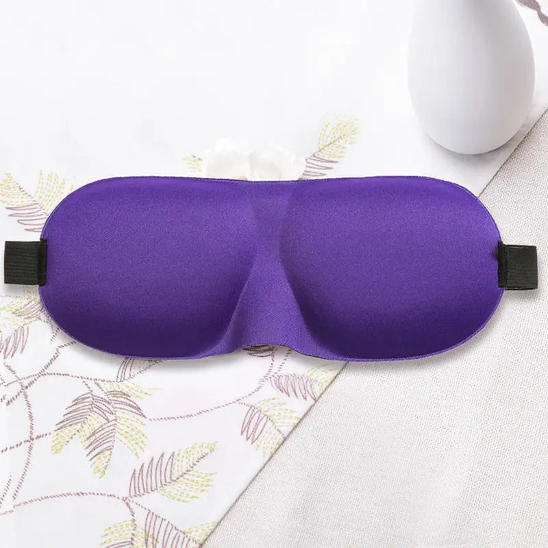 a purple eye mask with a black strap