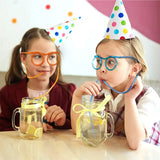 two young girls wearing party hats and glasses