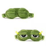 a close up of a green frog sleeping mask with eyes