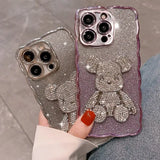 a woman holding two glitter iphone cases