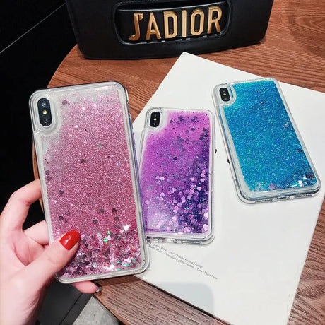 a woman holding a phone case with glitter on it
