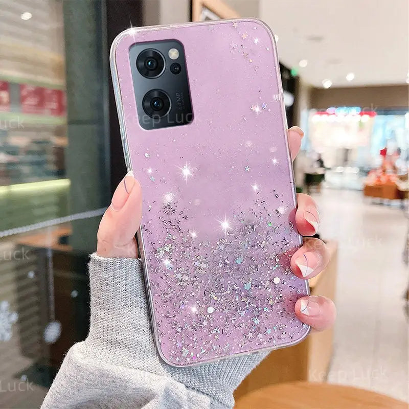 a woman holding up a purple phone case with glitter