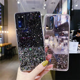 a hand holding a phone case with glitter and stars