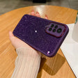 a woman holding a purple glitter phone case