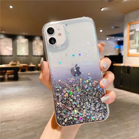 a woman holding a phone case with glitter