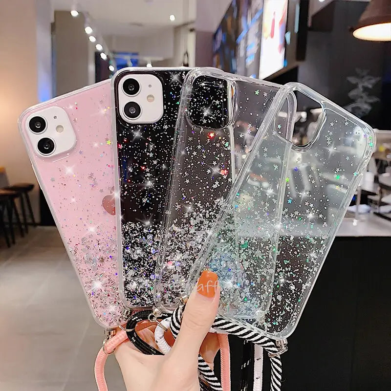 a woman holding up a phone case with glitter stars