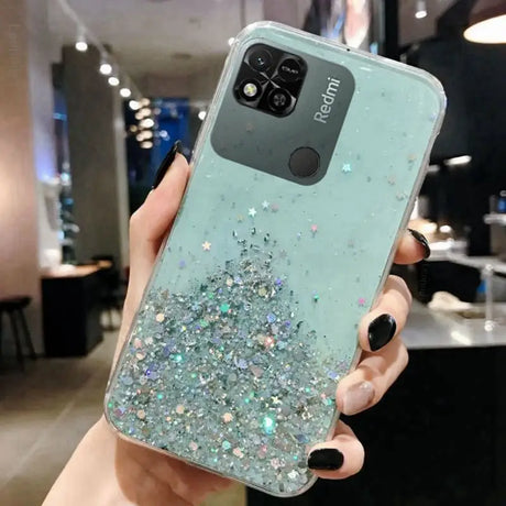 a woman holding a phone case with glitter