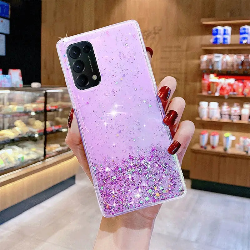 a woman holding a pink glitter phone case