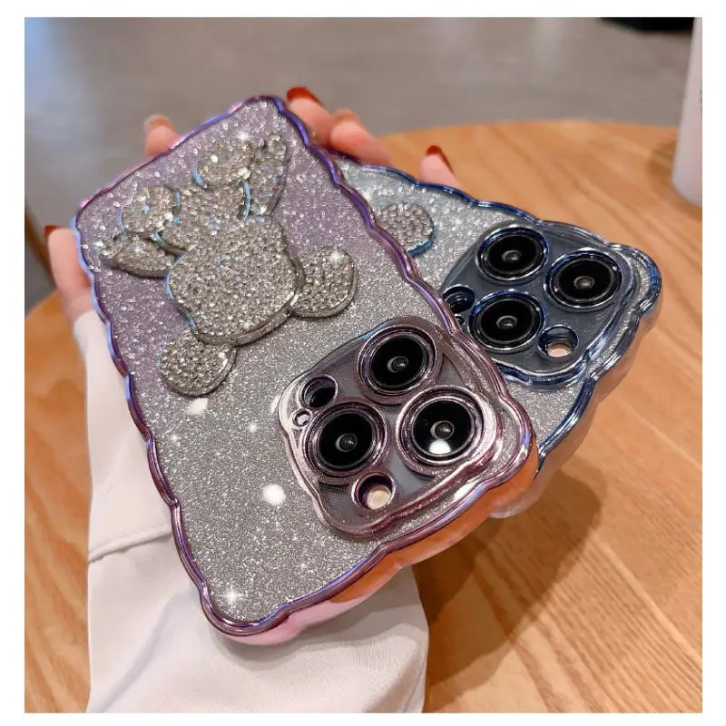 a pair of glitter phone cases with a bow