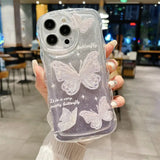 a woman holding a clear case with white butterflies on it