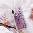 a woman holding a phone case with pink glitter