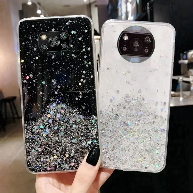 a hand holding a phone case with glitter