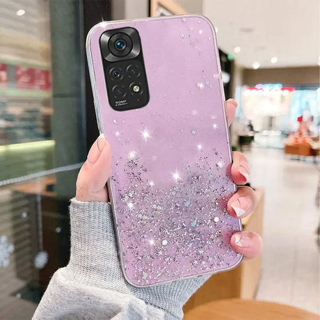 a woman holding up a purple phone case with glitter