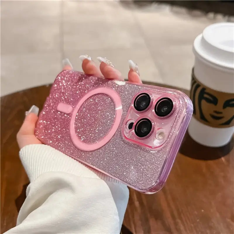 a girl holding a pink glitter phone case