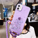 a woman holding a purple phone case with glitter and a purple strap