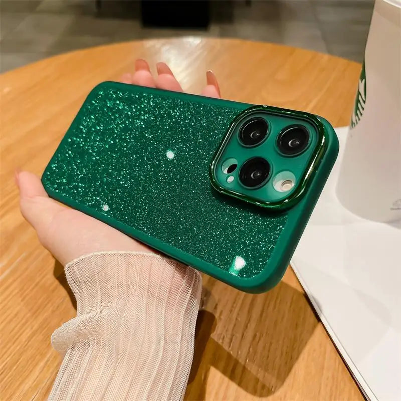 a person holding a green glitter phone case