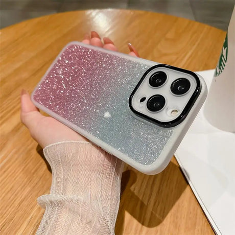 a woman holding a phone case with glitter on it