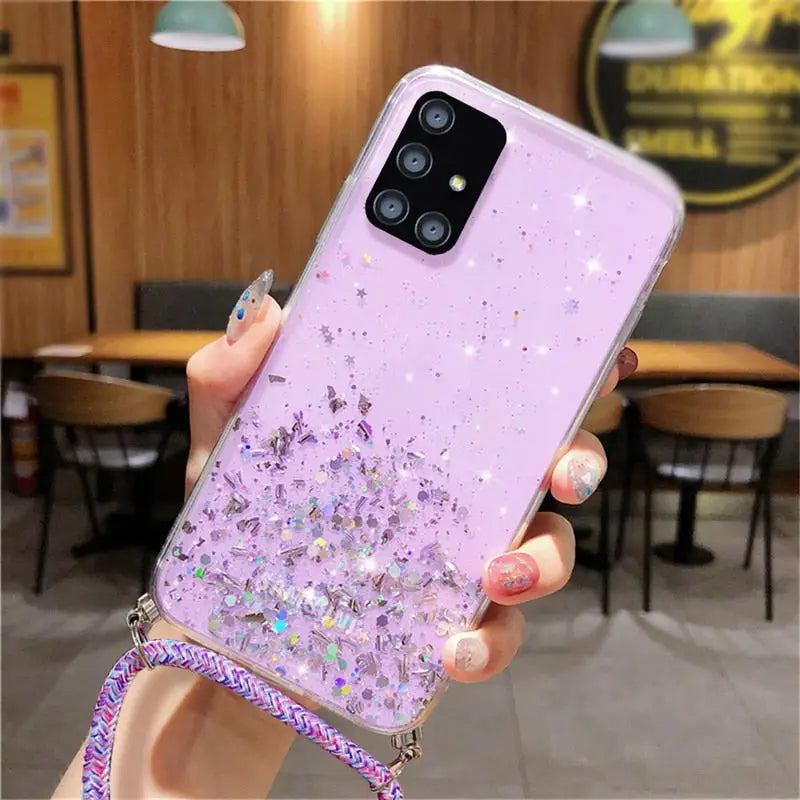 a woman holding a phone case with glitter and stars