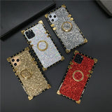 Glittery, bejeweled smartphone cases with ring holders in gold, silver, and red colors.