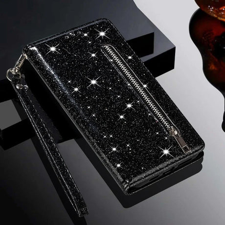 Glittery black wallet or clutch with a zipper and wrist strap.