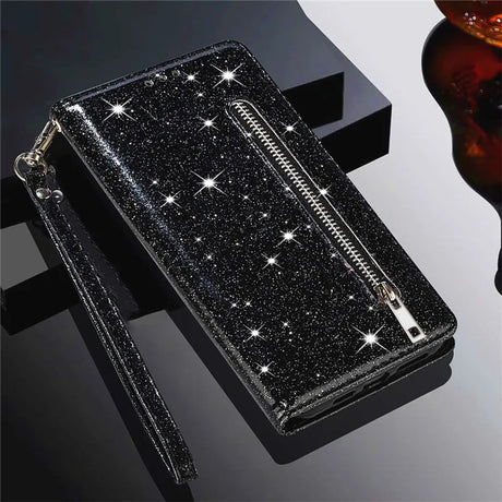 Glittery black wallet with a zipper and wrist strap.