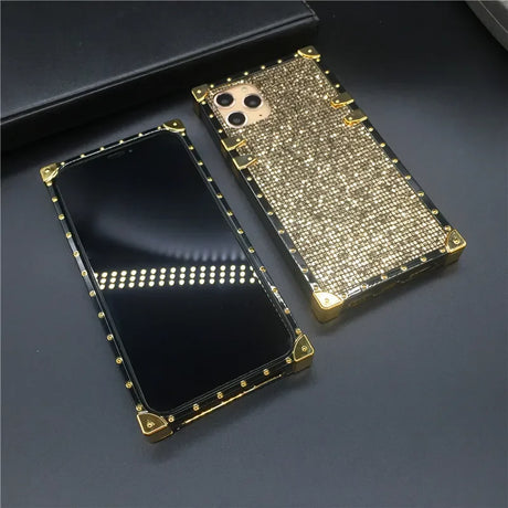 Glittery gold smartphone case with rhinestone embellishments and camera cutouts.