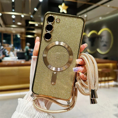 Glittery gold smartphone case with a circular ring holder and attached lanyard.