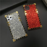 Glittery, jewel-encrusted smartphone cases in silver and red with gold-toned edges.