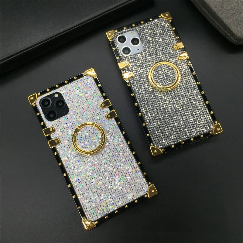 Glittery, jewel-encrusted smartphone cases with gold accents and ring holders.