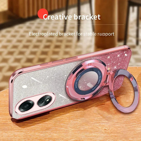 Glittery pink smartphone case with a built-in ring holder and camera protection.