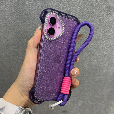 Glittery purple phone case with a rhinestone camera trim and a purple wrist strap with a pink adjuster.