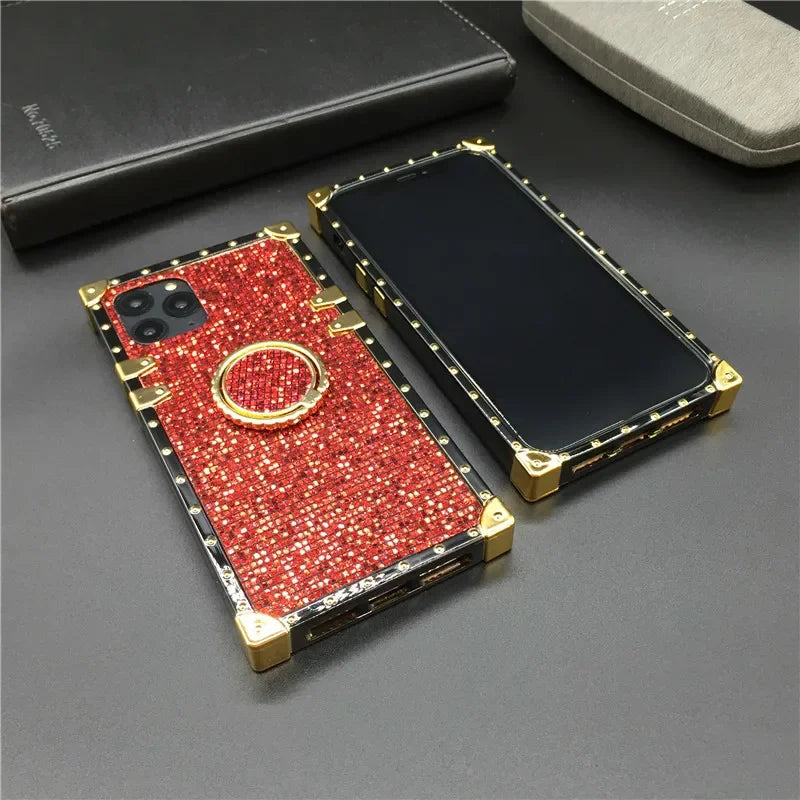 Glittery red smartphone case with gold accents and a ring holder.